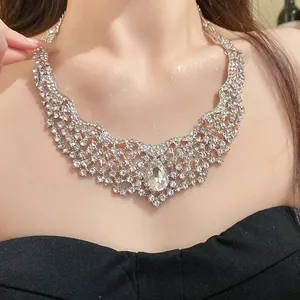 Close-up view of a sparkling hollow-out necklace with a large water drop pendant on a model