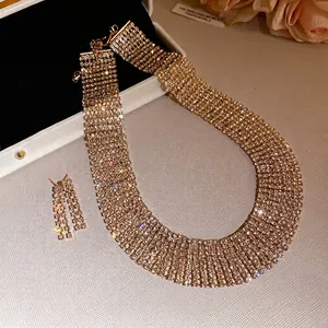Elegante set di collana girocollo e orecchini a nappa con strass dorati a più file.