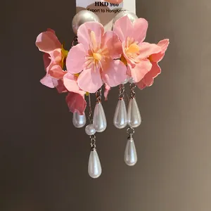 Detailed view of pink floral tassel earrings with elegant white pearl drops for women