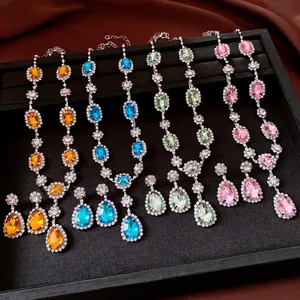 Luxury jewelry set with rhinestone oval and teardrop crystal pendants in four colors.