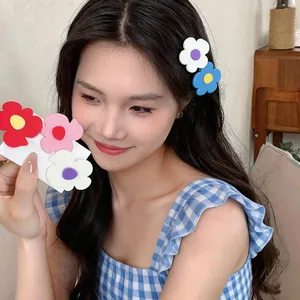 Detail shot of a model wearing vibrant colorful flower hair clips in a cute Korean style