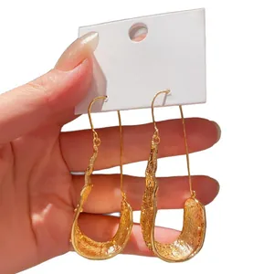 Elegant vintage gold U-shaped drop earrings featuring a unique textured liquid design