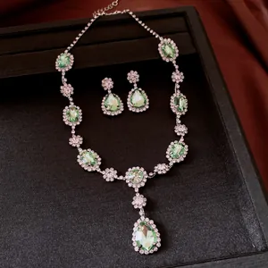 Detailed view of vintage-style light green crystal water drop necklace and earrings set