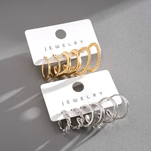 Close-up of a 6-piece geometric metal stud earring set in gold and silver finishes