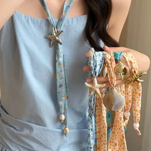 Summer ocean-style silk scarf necklace with shell and starfish pendants for vacation.