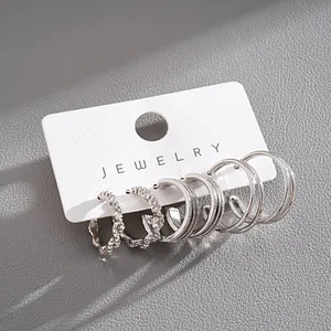 Detailed view of a 6-piece silver-colored geometric hoop earring set on a display card