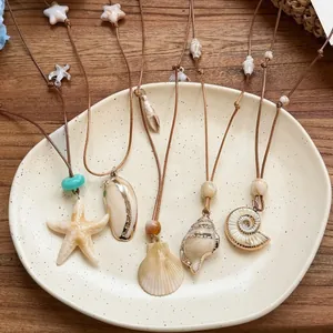 Elegant bohemian sea shell and starfish pendant necklace with brown adjustable leather cord