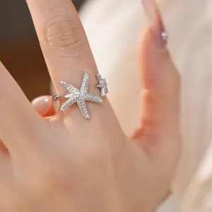 Macro view of zircon-inlaid silver starfish open ring with exquisite stone paving details.