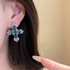 Elegant cross stud earrings with emerald-cut turquoise zircons and sparkling accents