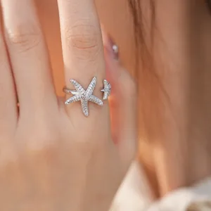 Detailed view of elegant silver starfish open ring inlaid with sparkling zircons