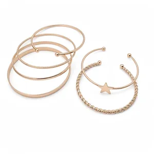 Elegant set of six rose gold retro style open bangles featuring a star charm and textures