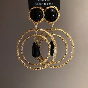 Vintage gold-tone drop earrings with black resin cabochon and textured double hoops