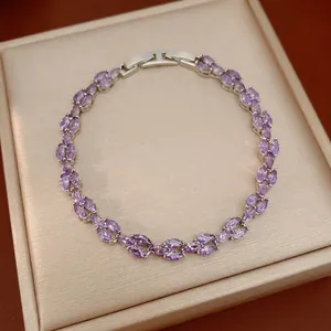 Elegant silver-tone bracelet featuring marquise-cut purple zircons on a luxury display pad