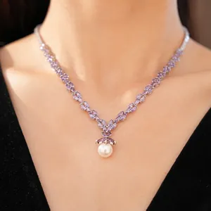 Elegant silver necklace with purple zircons and white pearl pendant on a model