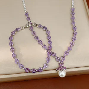 Detailed view of jewelry set featuring purple zirconia and a lustrous pearl pendant.
