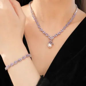Close-up of purple zircon and pearl necklace and bracelet set on a model