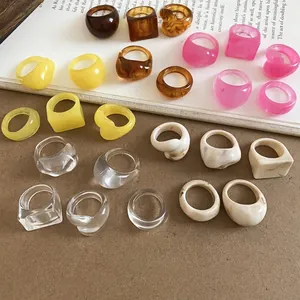 Set of chunky resin rings in various candy colors and geometric designs.