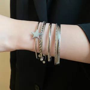 Silver-toned stacked bangle set featuring star charm and textured finishes for women