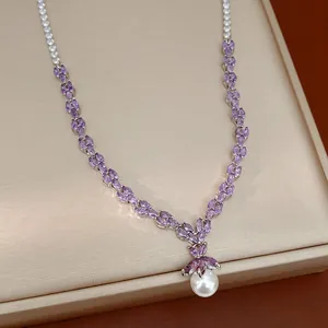 Elegant purple marquise zircon and round pearl pendant necklace on a jewelry board