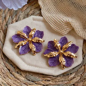 Elegant oversized purple flower stud earrings with a wrinkled gold metal accent detail