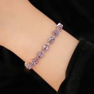 Detailed close-up showing a delicate purple marquise-cut zirconia bracelet on a wrist