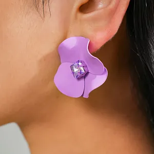 Detail of purple matte spray-painted flower earring with central purple crystal stud