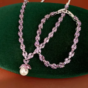 Detail of purple zircon necklace and bracelet set with elegant white pearl pendant.