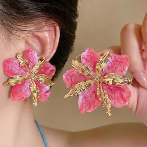 Elegant oversized pink enamel flower earrings with gold metallic petal details for women