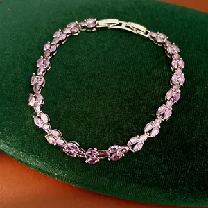 Detailed close-up of an elegant silver-toned bracelet with marquise-cut purple zircons.