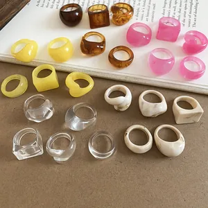 Detailed view of trendy candy color resin rings in various organic shapes and vibrant styles