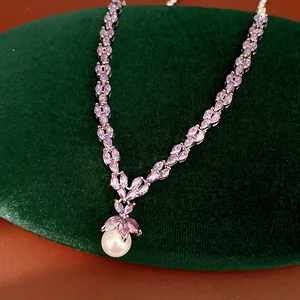 Detailed view of purple marquise zircon necklace with elegant white pearl drop pendant