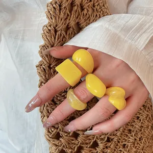 Detailed macro shot of chunky yellow resin rings set featuring bold geometric designs