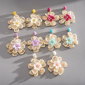 Handmade raffia flower earrings in multiple vibrant colors for vacation beach style.