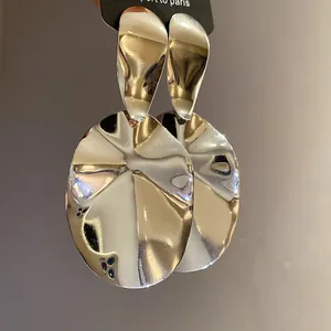 High-shine silver-finish oval drop earrings featuring a unique rippled metallic texture