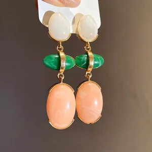 Elegant vintage resin oval drop earrings with white green and peach stones on gold setting