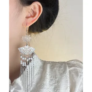 Detailed macro view of New Chinese style lotus long tassel earrings with white fan motif