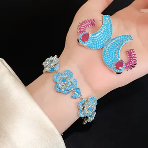 Dettaglio di un elegante bracciale e orecchini in zircone blu con motivi floreali