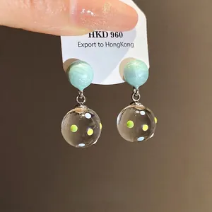 Minimalist silver needle resin earrings with mint green top and clear dotted hanging ball