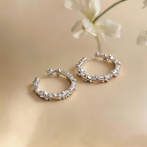Detailed macro shot of silver open rings featuring dainty stars and sparkling zircon inlay