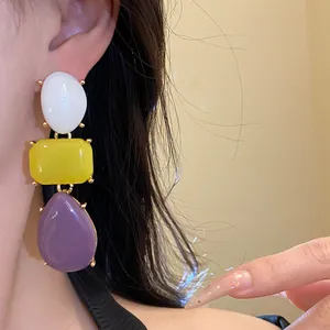 Detailed view of vintage colorful resin drop earrings featuring geometric segment designs.