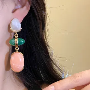 Elegant vintage oval resin drop earrings featuring marble textures worn by a model