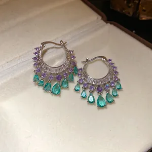 Detailed view of bohemian hoop earrings with purple and green zircon teardrop charms