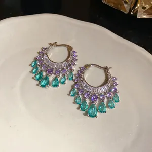 Elegant silver-toned hoop earrings featuring vibrant purple and teal teardrop zircon pendants