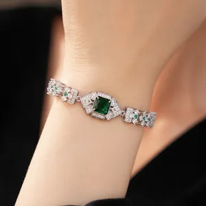 Gros plan d'un bracelet vintage Art Déco en argent avec pierre carrée vert émeraude