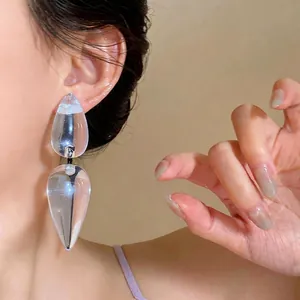 Bold transparent resin waterdrop stud earrings with silver pins for a modern luxury look.