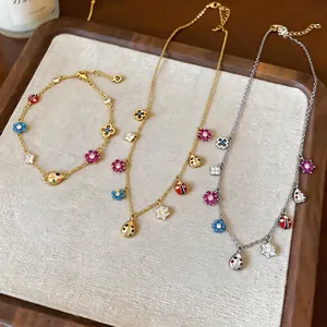 Elegant vintage jewelry set featuring zircon flowers and colorful enamel ladybug charms