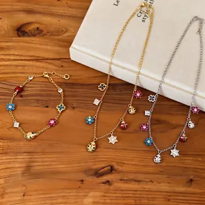Vintage jewelry set with enamel flower and ladybug charms on gold and silver chains