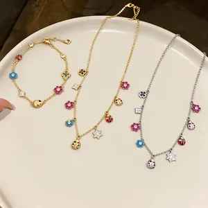 Vintage style enamel flower and ladybug jewelry set in gold and silver finishes