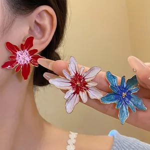 Elegant handcrafted enamel flower stud earrings in red, white and blue finishes.