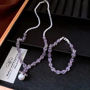 Elegant jewelry set with purple zircon necklace, pearl pendant and matching bracelet.